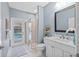 Updated bathroom with white vanity, quartz countertop, and walk-in shower at 12004 Marblehead Dr, Tampa, FL 33626