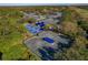 A wide aerial shot showing multiple tennis and pickleball courts within a lush community setting, ideal for sports enthusiasts at 122 E Cypress Ct # 22, Oldsmar, FL 34677