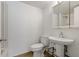 Bathroom featuring a pedestal sink, a toilet and a framed mirror at 122 E Cypress Ct # 22, Oldsmar, FL 34677