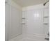 Bathroom shower and tub area featuring a white tile surround and built-in shelving at 122 E Cypress Ct # 22, Oldsmar, FL 34677