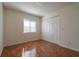 Clean bedroom with tile flooring, a window with blinds, a ceiling fan and a closet with sliding doors at 122 E Cypress Ct # 22, Oldsmar, FL 34677