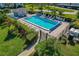 Aerial view of the community pool with lounge chairs, tables, and a covered pavilion at 122 E Cypress Ct # 22, Oldsmar, FL 34677