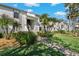 Low-rise condo building featuring mature landscaping, sidewalks, and convenient resident parking at 122 E Cypress Ct # 22, Oldsmar, FL 34677