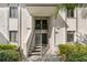 Condo building entrance with well-maintained landscaping and multiple unit access at 122 E Cypress Ct # 22, Oldsmar, FL 34677