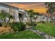 Condo exterior showcases lush landscaping, tropical palms, and beautiful sunset skies at 122 E Cypress Ct # 22, Oldsmar, FL 34677