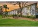 Condo exterior featuring palm trees and manicured lawns under a vibrant sunset sky at 122 E Cypress Ct # 22, Oldsmar, FL 34677