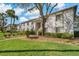 Exterior view of building two with landscaping and a large shade tree at 122 E Cypress Ct # 22, Oldsmar, FL 34677