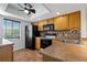 A bright kitchen offering tile flooring, wood cabinets, modern appliances, and a view from the window at 122 E Cypress Ct # 22, Oldsmar, FL 34677