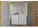 Laundry room with white washer and dryer and wire shelving for storage at 122 E Cypress Ct # 22, Oldsmar, FL 34677