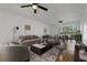 Bright living room with ceiling fan, neutral paint, and adjacent dining area with sliding glass door at 122 E Cypress Ct # 22, Oldsmar, FL 34677