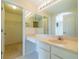 Bathroom features a vanity with double sinks and a walk-in closet at 1257 Corinth Greens Dr # 1257, Sun City Center, FL 33573