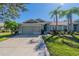 Exterior view of charming villa with attached garage and landscaped lawn at 1257 Corinth Greens Dr # 1257, Sun City Center, FL 33573