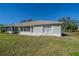 House exterior with a grassy backyard at 1257 Corinth Greens Dr # 1257, Sun City Center, FL 33573