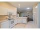 Bright kitchen with white cabinets, appliances, and tile floor at 1257 Corinth Greens Dr # 1257, Sun City Center, FL 33573