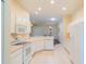 White kitchen with ample counter space and stainless steel appliances at 1257 Corinth Greens Dr # 1257, Sun City Center, FL 33573