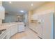 White kitchen features ample counter space and appliances at 1257 Corinth Greens Dr # 1257, Sun City Center, FL 33573