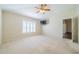 Spacious main bedroom with carpeted floors and ceiling fan at 1257 Corinth Greens Dr # 1257, Sun City Center, FL 33573