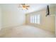 Main bedroom with carpeted floor and ceiling fan at 1257 Corinth Greens Dr # 1257, Sun City Center, FL 33573