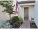 Inviting front entry with a dark gray door and fall decorations at 18172 Ramble On Way, Land O Lakes, FL 34638