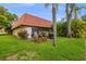 Landscaped backyard with a patio and lush greenery at 19029 Us Highway 19 N # 13F, Clearwater, FL 33764