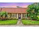 Charming single-story home with a tile roof, complemented by lush tropical landscaping and a well-manicured lawn at 19029 Us Highway 19 N # 13F, Clearwater, FL 33764