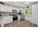 Updated kitchen with white cabinets, granite countertops, and stainless steel appliances at 19029 Us Highway 19 N # 13F, Clearwater, FL 33764