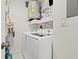 Convenient laundry room with washer, dryer, and shelving at 19029 Us Highway 19 N # 13F, Clearwater, FL 33764