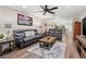 Open living room with leather couches and a large TV at 19029 Us Highway 19 N # 13F, Clearwater, FL 33764