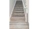 Interior staircase with gray carpeting and wood flooring at 2035 River Turia Cir, Riverview, FL 33578