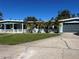 Light blue single story home with a large yard and two car garage at 205 81St Ne Ave, St Petersburg, FL 33702