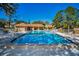 Community pool with lounge chairs and adjacent building at 2182 Clover Hill Rd, Palm Harbor, FL 34683