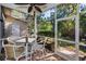 Screened porch with ceiling fan and table at 2182 Clover Hill Rd, Palm Harbor, FL 34683