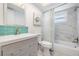 Bathroom with teal tile, white marble, and bathtub at 2240 Colonial Dr, Dunedin, FL 34698