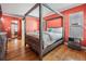 Main bedroom with canopy bed and coral walls at 2240 Colonial Dr, Dunedin, FL 34698