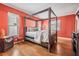 Bedroom with coral walls and a large canopy bed at 2240 Colonial Dr, Dunedin, FL 34698