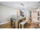 Bright dining room features a wood table, bench, and built-in shelving at 2240 Colonial Dr, Dunedin, FL 34698