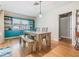 Dining area with teal built-ins and wood table with bench at 2240 Colonial Dr, Dunedin, FL 34698