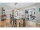 Dining room with wood floors, table and access to the backyard at 2240 Colonial Dr, Dunedin, FL 34698