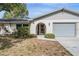 Single-story home with attached garage and manicured lawn at 2240 Colonial Dr, Dunedin, FL 34698
