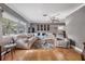 Bright living room with hardwood floors and a large sectional sofa at 2240 Colonial Dr, Dunedin, FL 34698