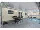 Covered patio with table and chairs, adjacent to the pool at 2240 Colonial Dr, Dunedin, FL 34698