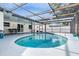 Kidney shaped pool with screened enclosure at 2240 Colonial Dr, Dunedin, FL 34698