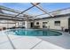 Kidney shaped pool with screened enclosure at 2240 Colonial Dr, Dunedin, FL 34698