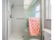 Walk-in shower with grab bars and polka dot towel at 2240 Colonial Dr, Dunedin, FL 34698