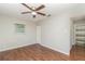 Spacious bedroom with wood-look floors, ceiling fan and adjacent bathroom at 2618 Nassau St, Sarasota, FL 34231