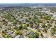 Birds-eye view of a lush, tree-filled neighborhood with various home styles and the city skyline afar at 2729 36Th N Ave, St Petersburg, FL 33713
