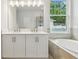 New bathroom features a double sink vanity, large window, and a tub at 2729 36Th N Ave, St Petersburg, FL 33713