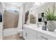 Modern bathroom with double vanity, bathtub, and glass-enclosed shower at 2729 36Th N Ave, St Petersburg, FL 33713