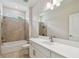 Bathroom showcasing a vanity with storage, a large mirror, and a shower-tub combo with tiled surround at 2729 36Th N Ave, St Petersburg, FL 33713