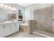 Modern bathroom with dual sinks, soaking tub, and walk-in shower at 2729 36Th N Ave, St Petersburg, FL 33713